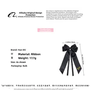 Detail of black satin bow hair clip with gold Team Bride text and size dimensions