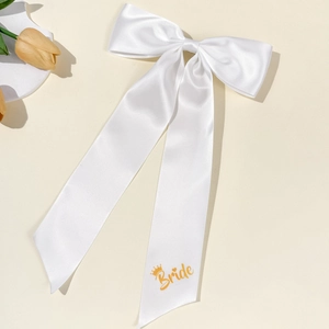 Elegant white satin bridal bow hair clip with gold Bride lettering and crown