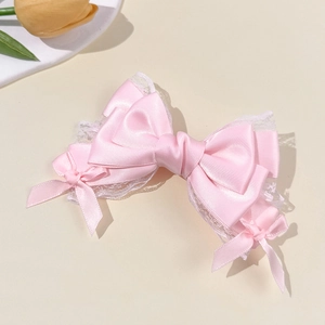 Pink satin bow hair clip with white lace trim for women in an elegant princess style