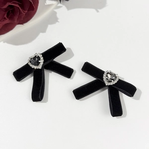 Detail of velvet bow hair clips with rhinestone hearts and black crystal centers