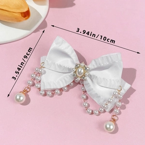 Detail of white satin bow hair clip with pearls and rhinestones showing size 10x9cm