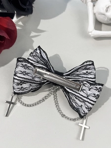 Detailed gothic bow hair clip with lace layers and metallic cross charms on grey background