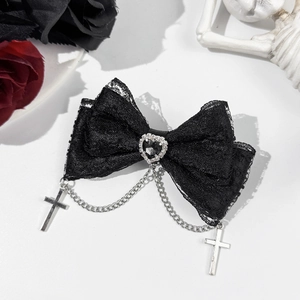 Detail of gothic black lace bow hair clip with heart gem and silver cross chains