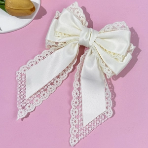 Elegant cream lace bow hair clip with satin layers and flowing long ribbons for women