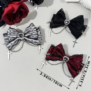 Detail of gothic lace bow hair clips with heart rhinestones and cross pendants