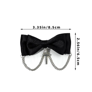 Detail of black bow hair clip with silver cross pendant and metal chains with size guide