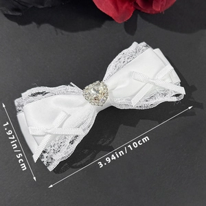 Detailed view of lace bow hair clip with heart rhinestone and 10cm size measurement