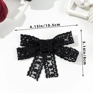 Detail view of black lace bow hair clip with size dimensions 4.13x3.14 inches
