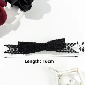 Detailed view of a 16x2cm black lace bow hair clip with intricate gothic floral patterns