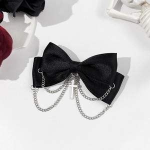 Gothic black satin bow hair clip with silver chains and cross pendant on white background