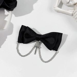 Gothic punk hair clip featuring a black satin bow with silver chains and cross pendant