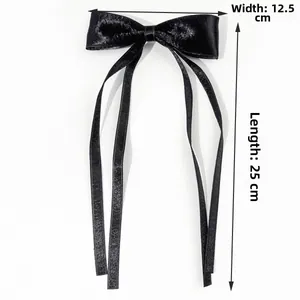 Detail view of the black satin bow hair clip with dimensions 12.5cm wide and 25cm long