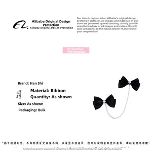 Detail view of pearl bow hair clips with metal chains weighing 20.4g on white background