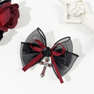 Gothic hair clip detail with black lace, red ribbon, textile rose and silver cross pendant