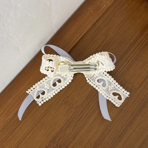 Cream lace bow hair clip with blue ribbon heart pattern and silver metal duckbill clip