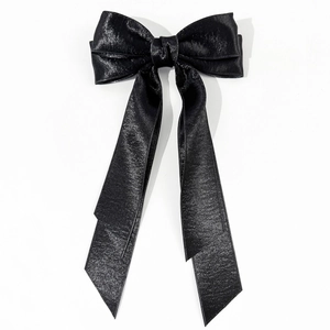 Elegant French style black satin ribbon hair bow clip with long streamers on white backdrop