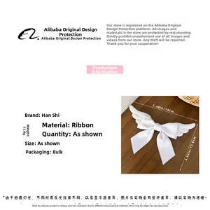 Detail view of plush wings bow hair clip with size 19x12.5cm and ribbon texture