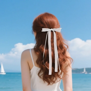 Close-up of a white ribbon bow hair clip with long streamers on a half-up hairstyle