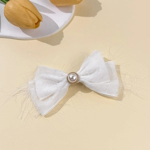 Elegant white chiffon bow hair clip with faux pearl detail and textured fringe edges