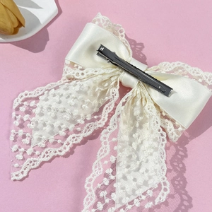 Elegant cream lace bow hair clip with satin layers and silver metal duckbill clip