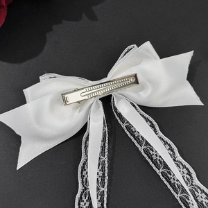 Elegant white lace bow hair clip with long ribbons featuring premium satin texture