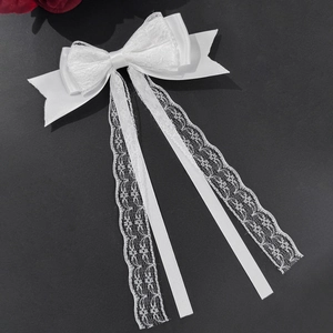 Elegant white lace ribbon bow hair clip with long tassels for women on gray background