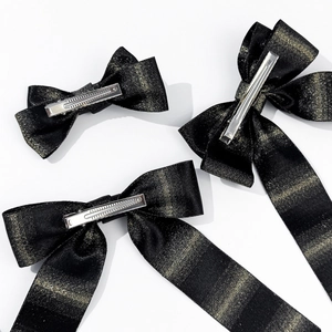 Elegant black and gold glitter satin bow hair clips with long streamers for women