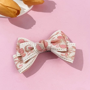Pink floral embroidered bow hair clip for women with elegant gold silk threading detail