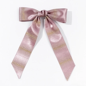 Detail view of pink satin bow hair clip with gold metallic stripes and elegant silk texture