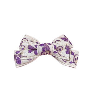 Ethnic style cream bow hair clip with purple floral embroidery and gold stitching