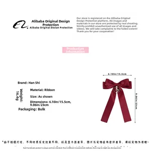 Detail view of burgundy ribbon bow hair clip with heart pendant and 16.4g weight specification