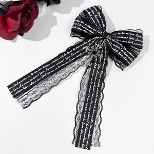 Gothic black lace bow hair clip with silver cross pendant and white lettering