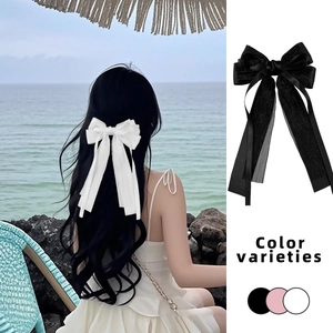 Pince à cheveux élégante avec double nœud et longs rubans en organza blanc et noir