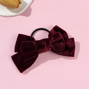 Detail of burgundy velvet layered bow scrunchie with high elasticity black rubber band