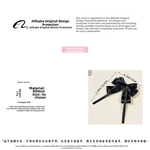 Detail view of a 9.6g black satin ribbon bow hair clip measuring 18.5x12cm