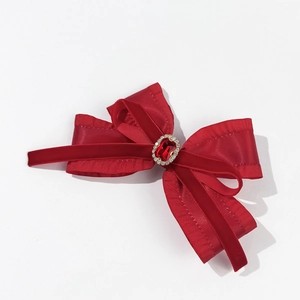 Elegant red velvet and satin bow hair clip with large ruby gemstone and crystal accents