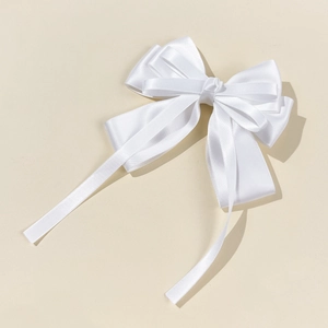 Elegant white satin bow hair clip with long ribbons for women, minimalist style