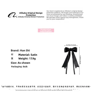 Detail view of a black satin ribbon bow hair clip with 13.5cm width and 25cm height dimensions