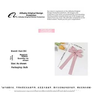 Detail view of the pink ribbon bow hair clip showing dimensions of 23cm by 13cm and 8.2g weight