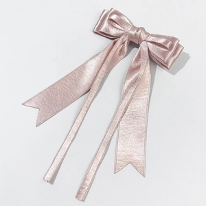 Detailed view of pink silky satin double-layered bow hair clip with elegant long ribbons