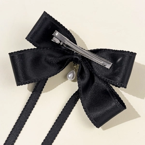 Elegant black satin bow hair clip with hanging pearl pendant and long ribbon tassels