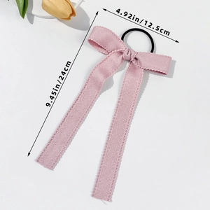 Pink lace bow hair tie with long ribbons showing satin texture and dimensions 24cm by 12.5cm