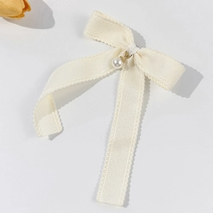Elegant cream white bow hair clip with pearl pendant in a minimalist retro style
