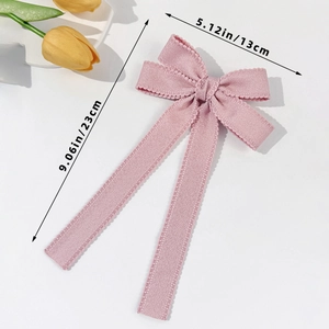 Pink ribbon bow hair clip with long streamers and wavy knit edges, 5.12x9.06 inches