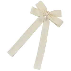 Elegant cream white bow hair clip with wavy scalloped edges and long flowing ribbons
