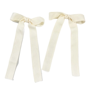Set of two cream white lace ribbon bow hair clips with elegant wavy edge details