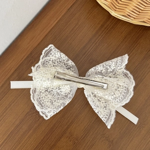 Elegant white lace bow hair clip with floral pattern and silver metal duckbill clip
