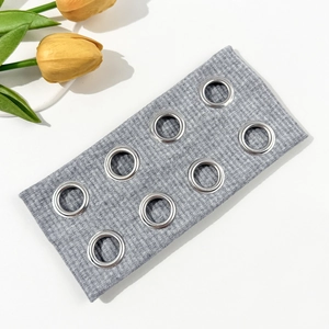 Industrial style grey ribbed headband featuring eight silver metal eyelets on white background