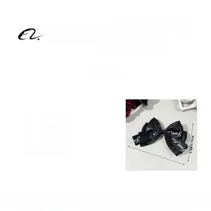 Detail of black ribbon bow hair clip with letter print, size 14x9cm and weight 8.8g