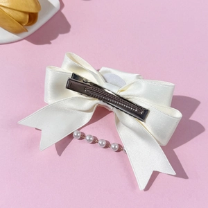 Elegant off-white satin bow hair clip with pearl tassels and silver alligator grip